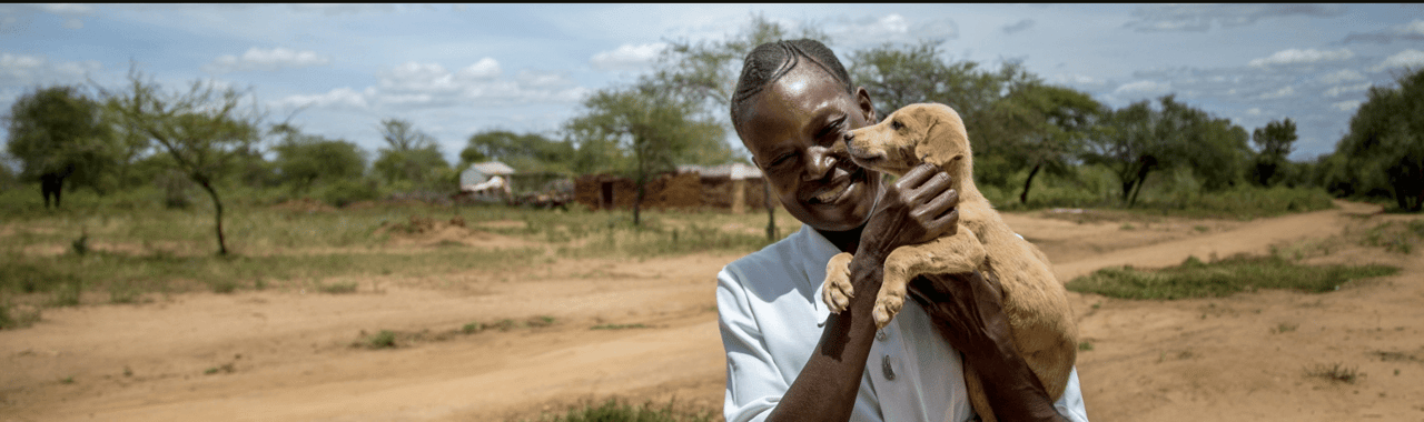 Man in Kenya Holding a Puppy