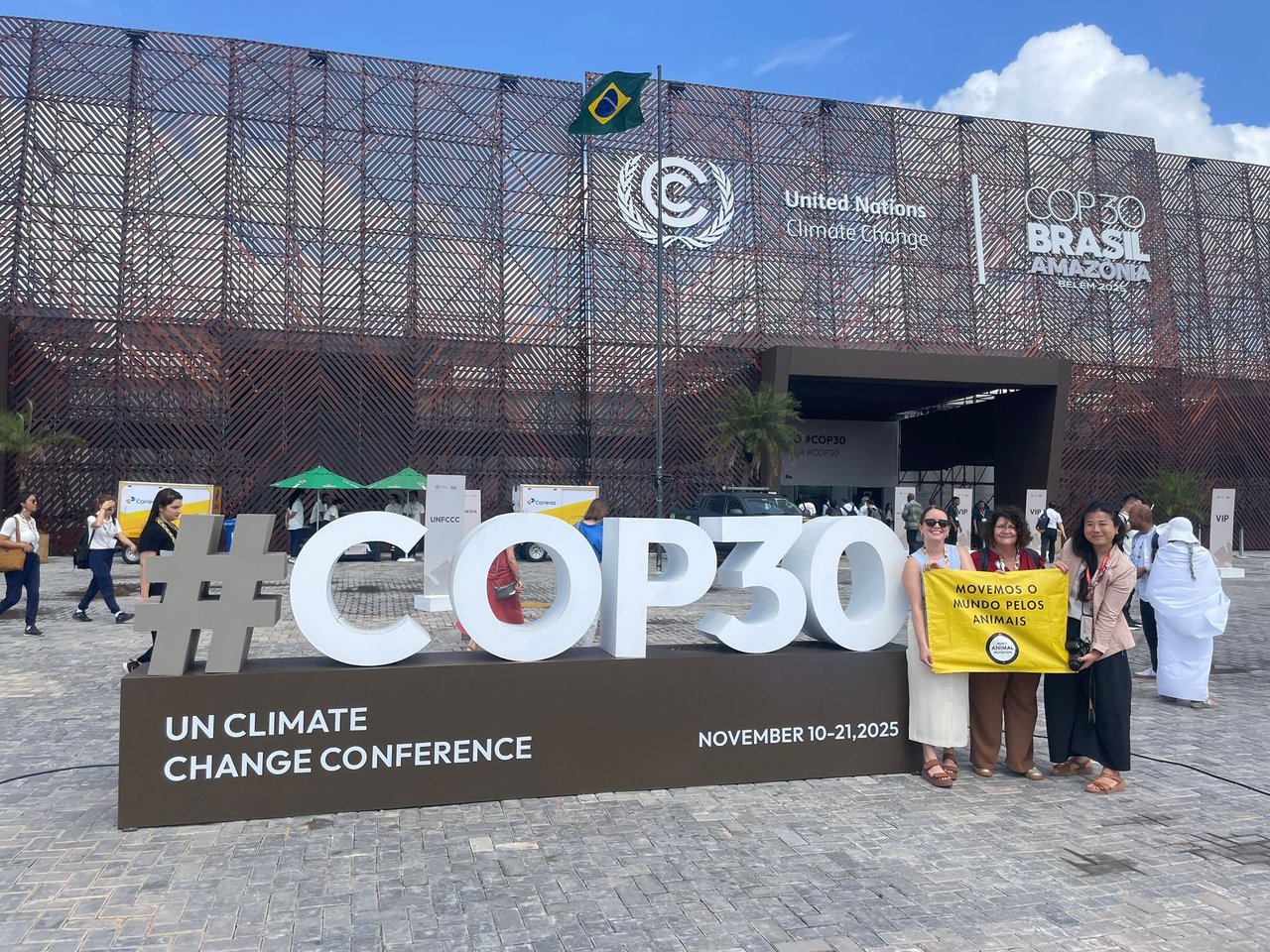 World Animal Protection staff standing beside the large #COP30 sign outside the UN Climate Change Conference venue in Belém.