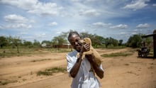 Man holding his dog in Kenya