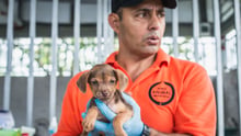 Sergio Vásquez holding a dog in the Parismina community of Limon, Costa Rica - Animals in disasters - World Animal Protection