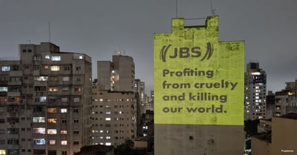 On the annual meeting of shareholders of JBS in Brazil World Animal Protection Brazil put up projections through out the streets of Sao Paulo, the biggest city in Brazil and one of the biggest cities in the world, to show how JBS causes animal suffering and contribute towards climate change. The projections were focused on stores that are part of JBS brand so people can connect the products that they are consuming with these important issues. This activity is part of the main goal to toxify JBS. Image credit: Projetemos