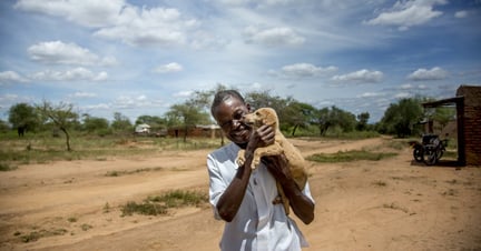 Man holding his dog in Kenya